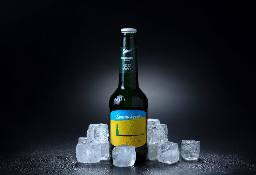 Packshot of beer bottles with ice cubes
